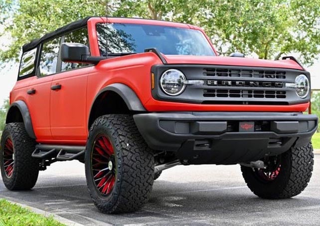 image of a custom Bronco in red with red accents on the rims