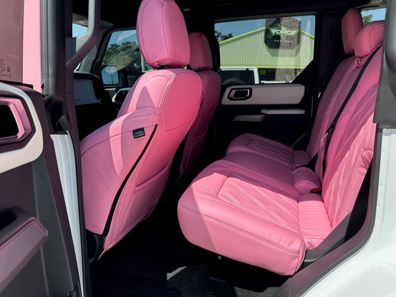 Pink ford bronco passenger side view back seat