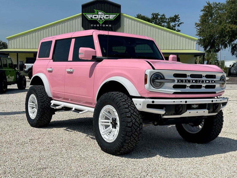 Pink ford bronco passenger side view