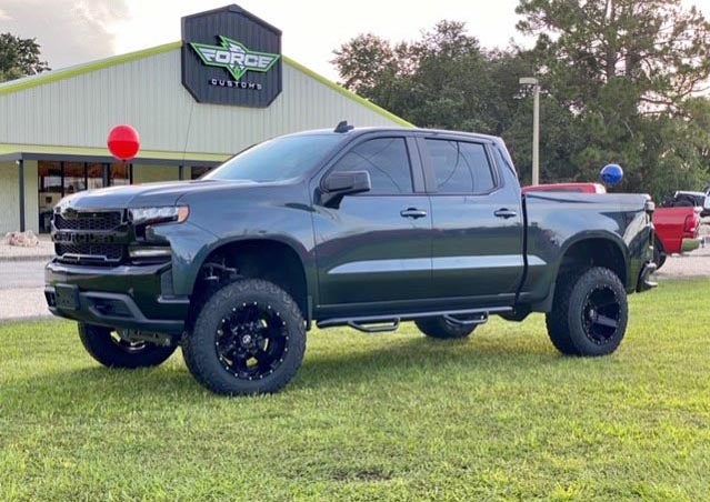 image of a dark green custom truck